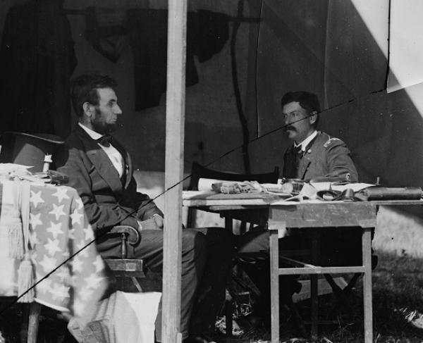 Photograph of McClellan discussing business in a tent