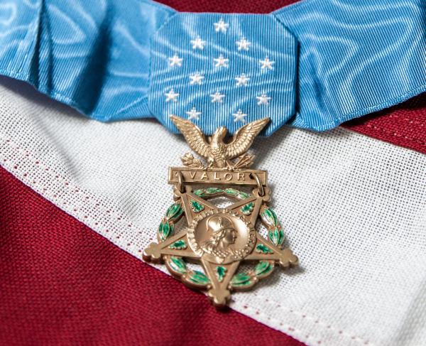 A picture of a Medal of Honor on top of an American flag
