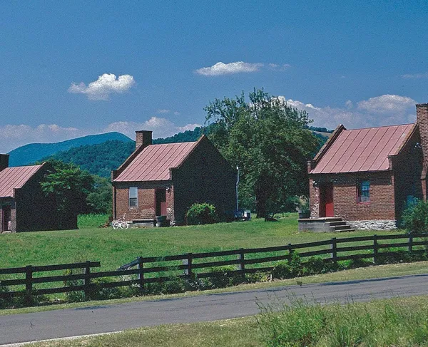 Slave cabins at Ben Venue stand on a the hilltop amidst Blue Ridge Mountains.