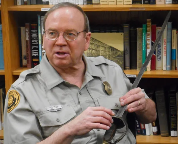 Portrait of historian holding a Civil War sword