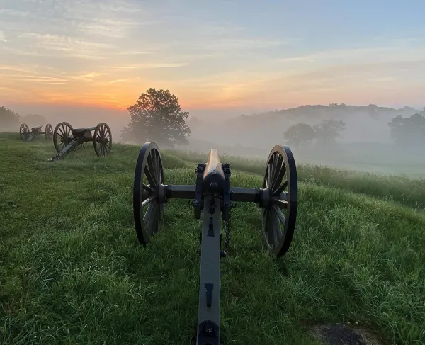 Cannons atop East Cemetery Hill on a misty summer morning.