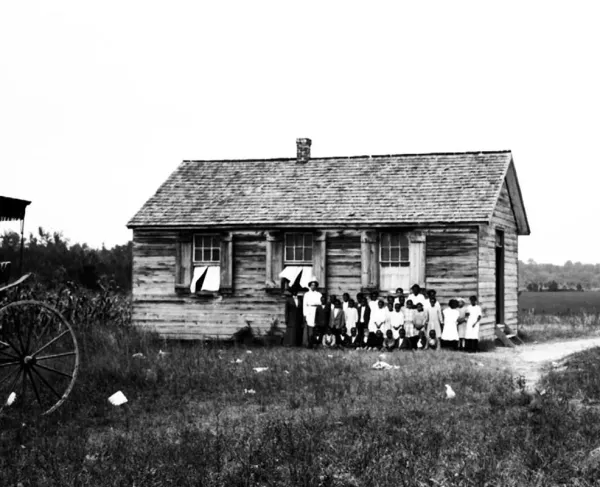 This image, likely from the early 20th century, shows noted educator Virginia Randolph and students outside the school in Gravel Hill.