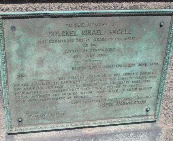 A bronze memorial plaque mounted on stone honors Colonel Israel Angell, featuring an engraved tribute letter from George Washington.