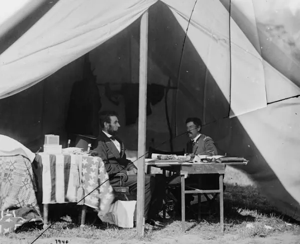 Photograph of Lincoln and McClellan seated somewhere at Antietam
