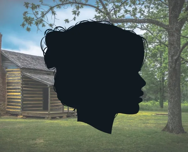 Silhouette of a woman's face in front of a log cabin and a forest.