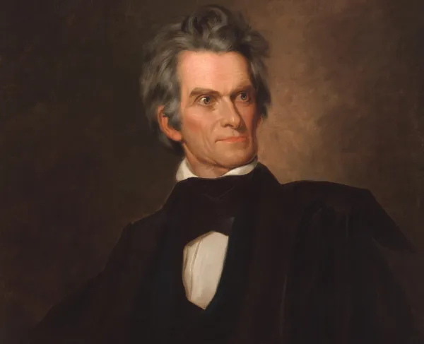 Oil portrait of John C. Calhoun seated in a chair, wearing a dark coat and black cravat.