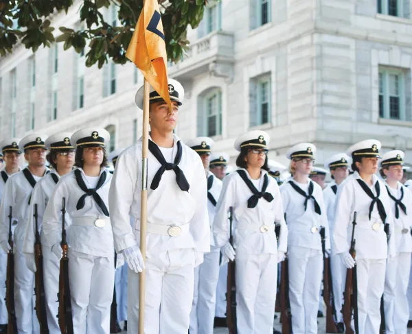 Midshipmen at the Naval Academy in classic navy sailor uniform