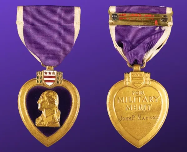 A front and back view of a Purple Heart medal