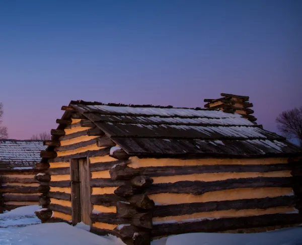 Snow at dawn near the recreated cabins at Valley Forge National Historical Park in King of Prussia, Pa. 