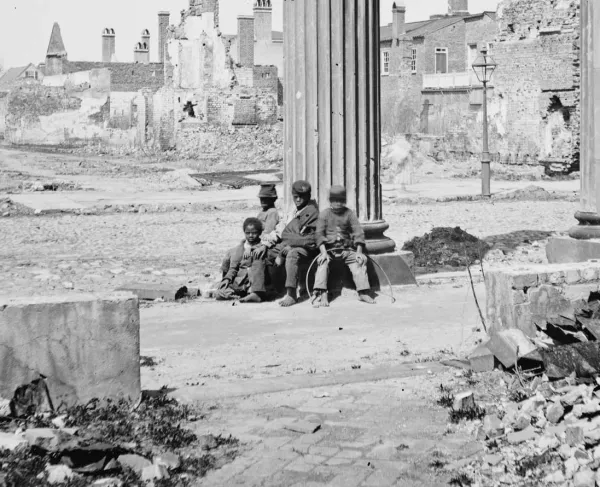 Civil War-era photograph showing ruined buildings in Charleston, South Carolina, framed by the porch of the Circular Church at 150 Meeting Street.