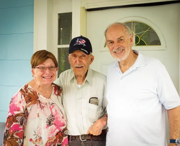Ed Bearss standing between Dru & Bill Vodra outside his front door