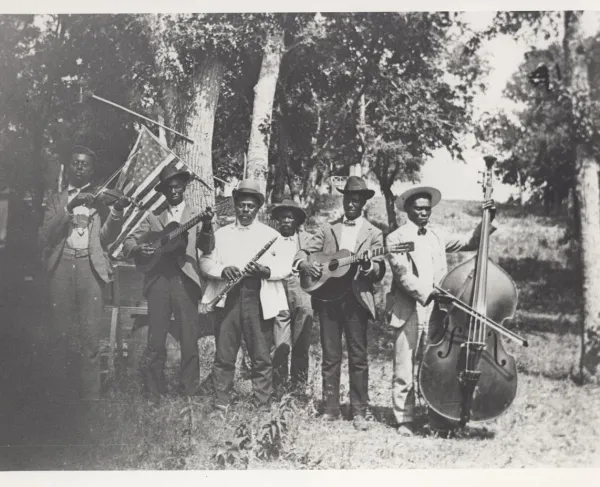 This is a black and white photo of a band playing various instruments during the Juneteenth celebration. 