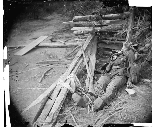 This photograph shows a soldier lying dead in the rubble of Spotsylvania. 