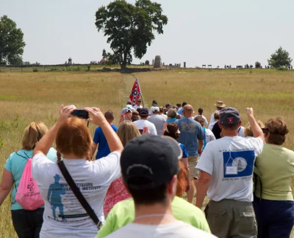 Teachers attending the American Battlefield Trust Teacher Institute follow in the Confederates' footsteps as they approach the Copse of Trees