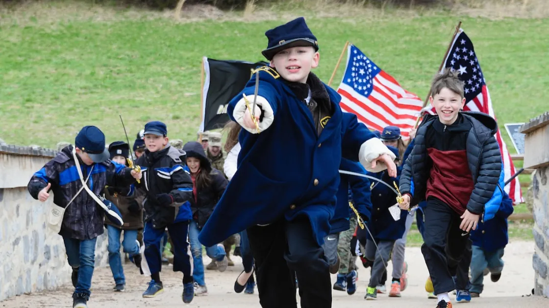 Generations participants charge across Burnside Bridge at Antietam National Battlefield, Md.