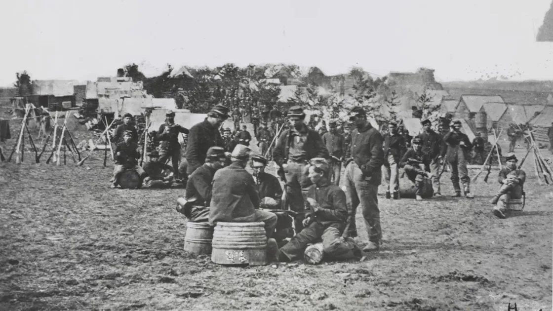 Soldiers playing cards in camp