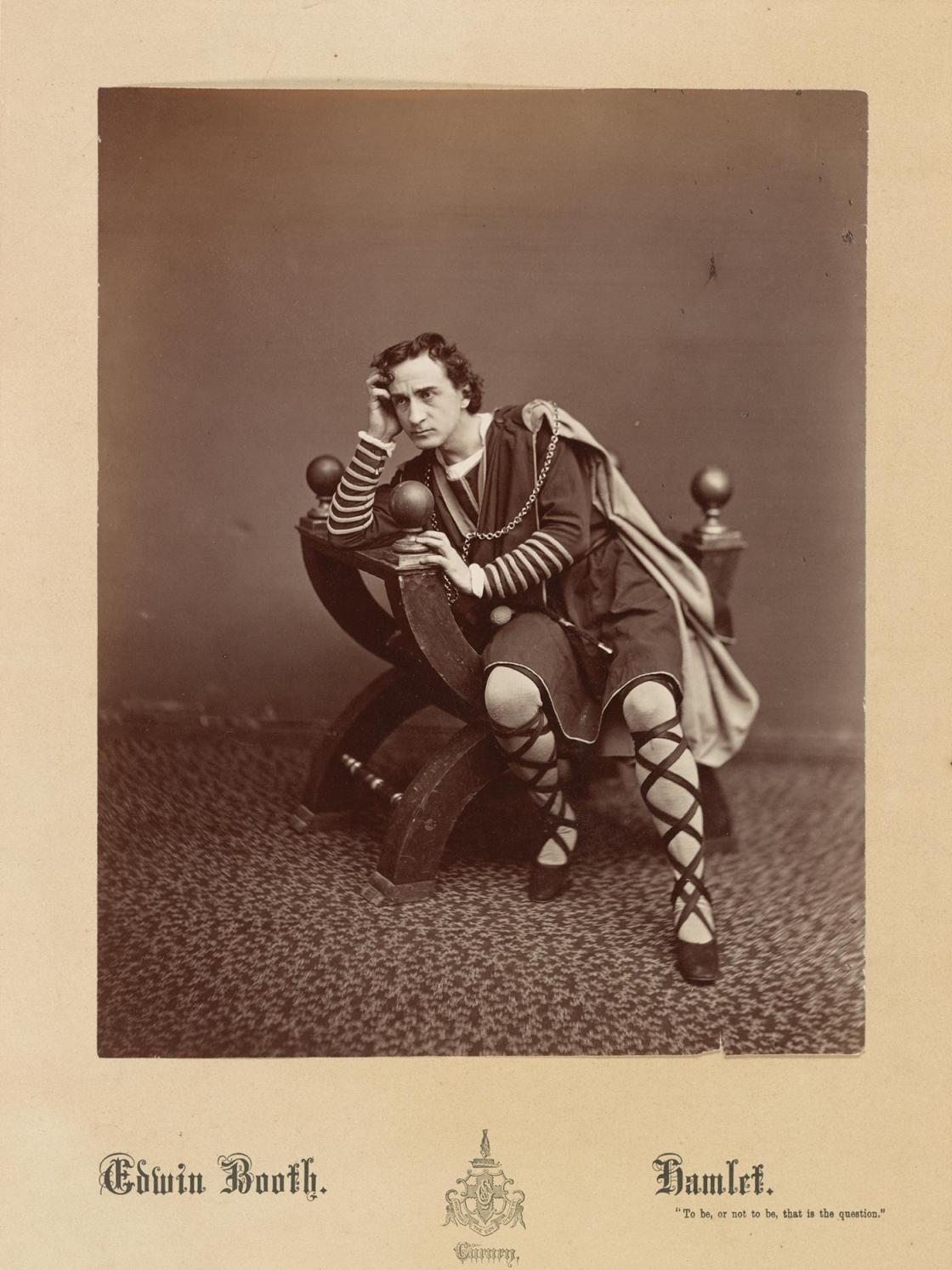 19th century sepia portrait of an actor with elaborate shoes and cape leaning on a unique chair