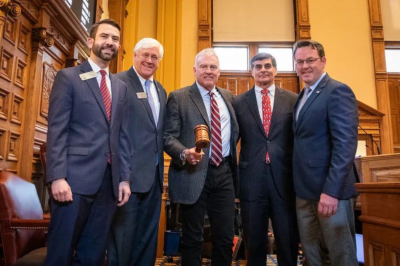 Left to right: Rep. Houston Gaines, Sen. Bill Cowsert, Chris Welton, Frank Ros, and Lt. Gov. Burt Jones celebrate the bill's passage on the floor of the Georgia Senate.