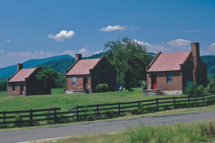 Slave cabins at Ben Venue stand on a the hilltop amidst Blue Ridge Mountains.