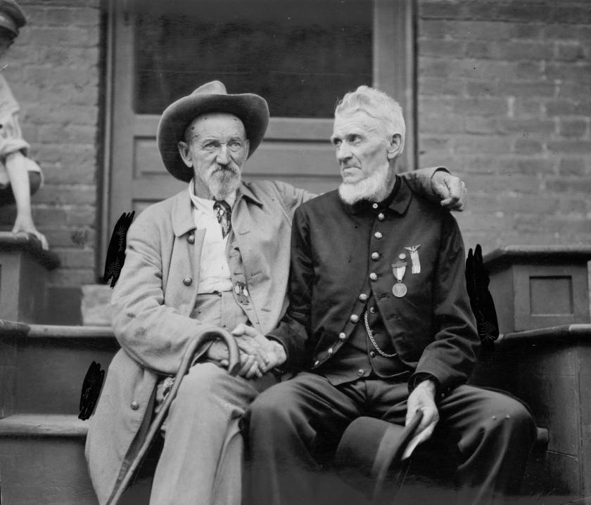 A black and white photo of veterans clasping hands