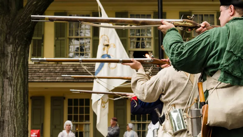 Re-enactors firing in front of Indian King Tavern