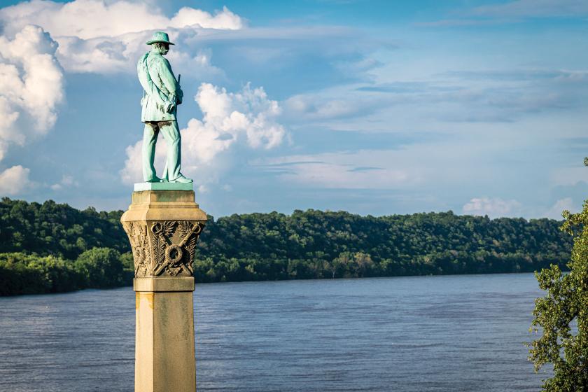 View of Confederate statue on a pillar from behind, overlooking a river