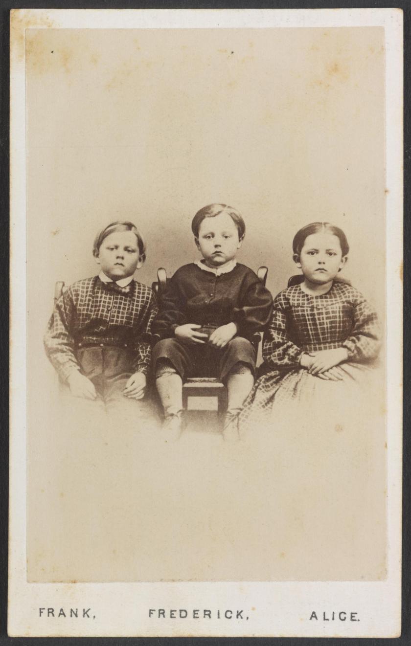 A photograph of three children labeled Frank, Frederick and Alice