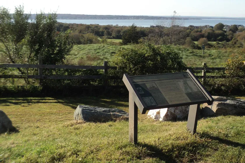 The Narransett Bay, where the French fleet arrived prior to the Battle of Rhose Island, can be seen behind the interpretive marker at Rhode Island Battlefield in Portsmouth, Rhode Island. 