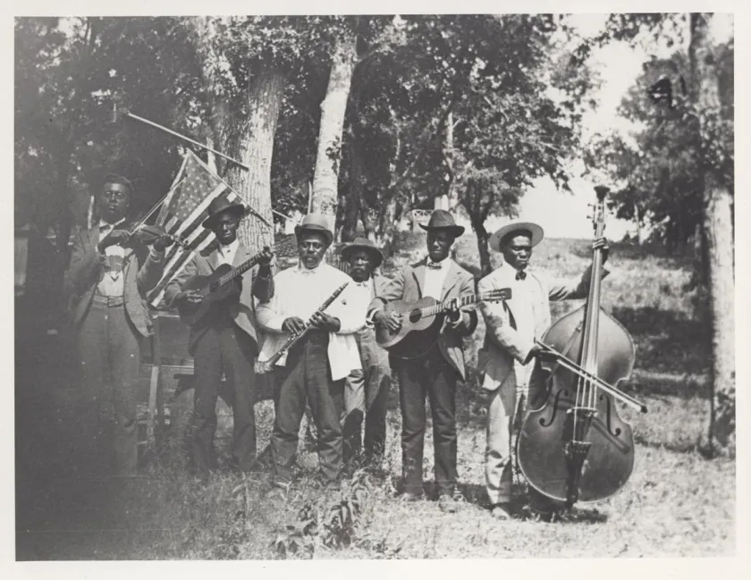 This is a black and white photo of a band playing various instruments during the Juneteenth celebration.