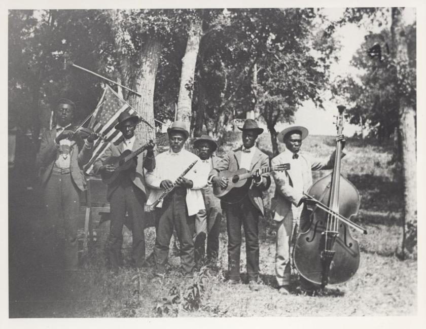 This is a black and white photo of a band playing various instruments during the Juneteenth celebration. 