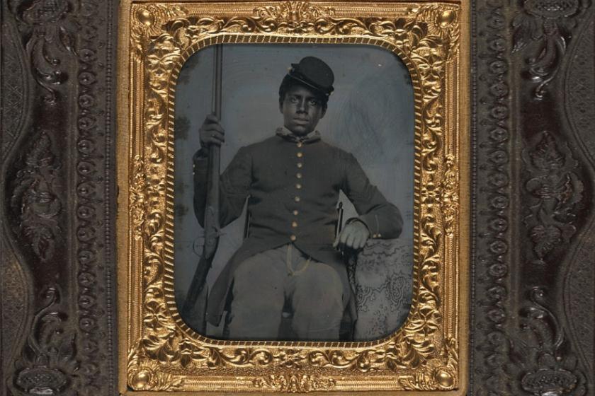 Unidentified African American soldier in Union sergeant uniform holding a rifle