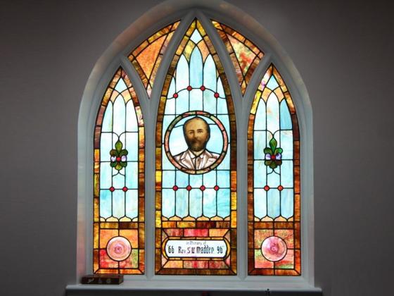 Stained glass at Alfred Street Baptist Church depicting Reverend Madden