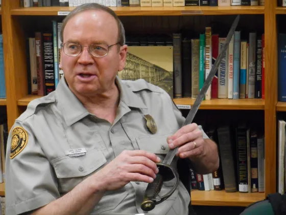 Portrait of historian holding a Civil War sword