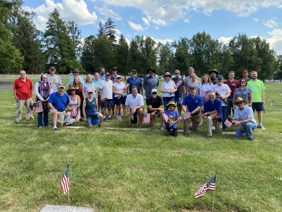 Trust staff and friends place flags in the soldiers national cemetery at Gettysburg