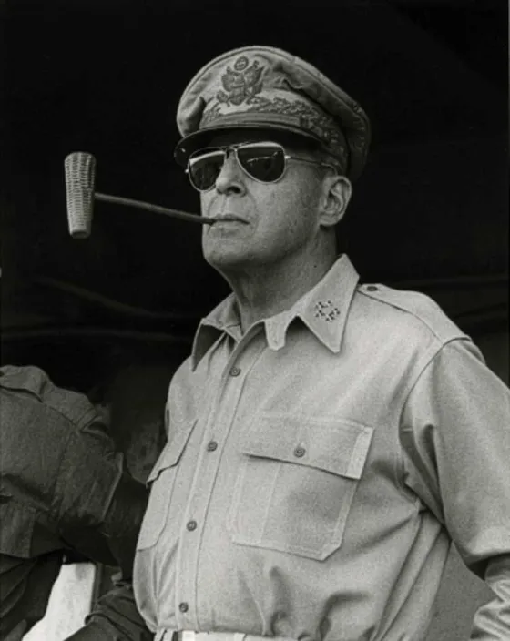 Gen. Douglas MacArthur smoking a corn cob pipe, 1945.