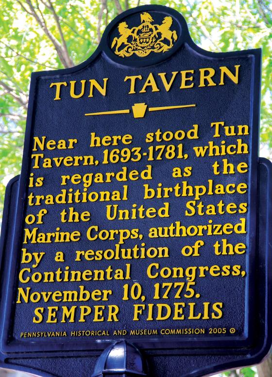 Vertical historical marker that reads: Tun Tavern, Near here stood Tun Tavern. 1793-1781, which is regarded as the traditional birthplace of the United States Marine Corps, authorized by a resolution of the Continental Congress, November 10, 1775.