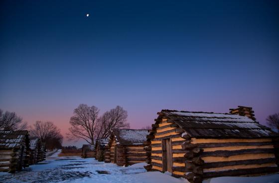Snow at dawn near the recreated cabins at Valley Forge National Historical Park in King of Prussia, Pa.
