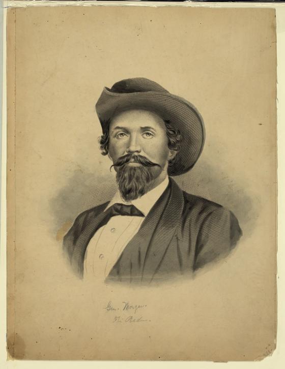 19th century portrait of man with a handlebar mustache wearing a western-type hat and a suit
