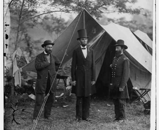 This is a black and white photograph of Lincoln, Pinkerton, and McClernand near Antietam. 