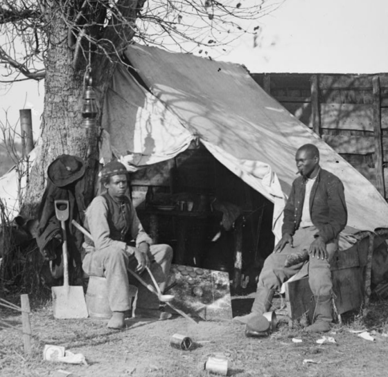 This image depicts two "contrabands"— formerly enslaved African Americans— at Culpeper, VA. 