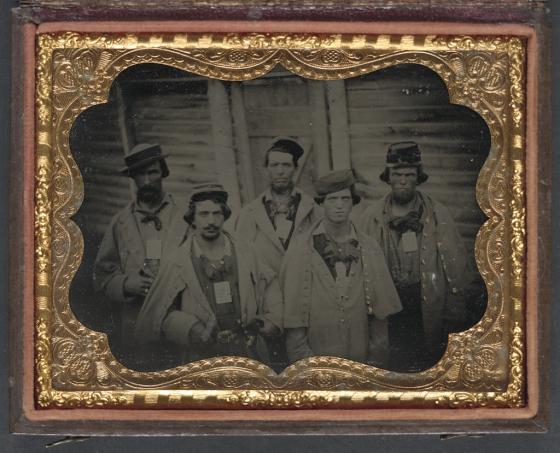 This is a photograph of five unidentified Confederate prisoners in front of their barracks at Camp Douglas.