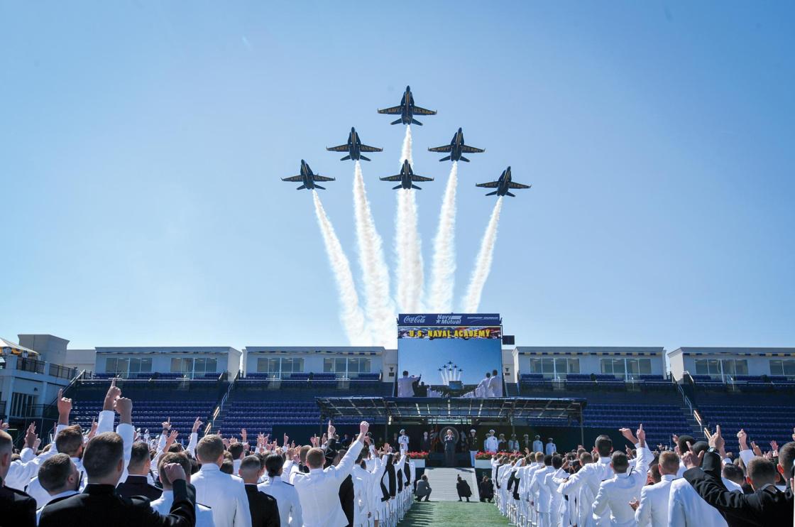 Six Blue Angels fly in formation over a stadium during Naval Academy graduation