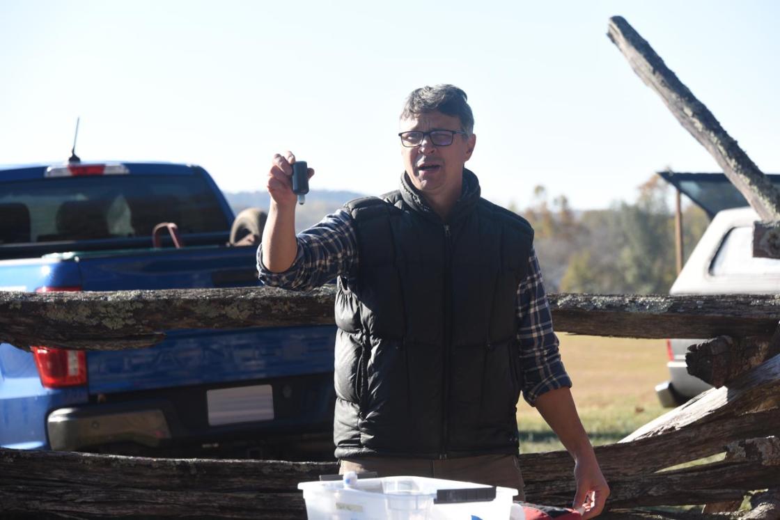 Tom explains herbicide safety and equipment to volunteers.