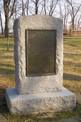 A stone monument with a bronze plaque