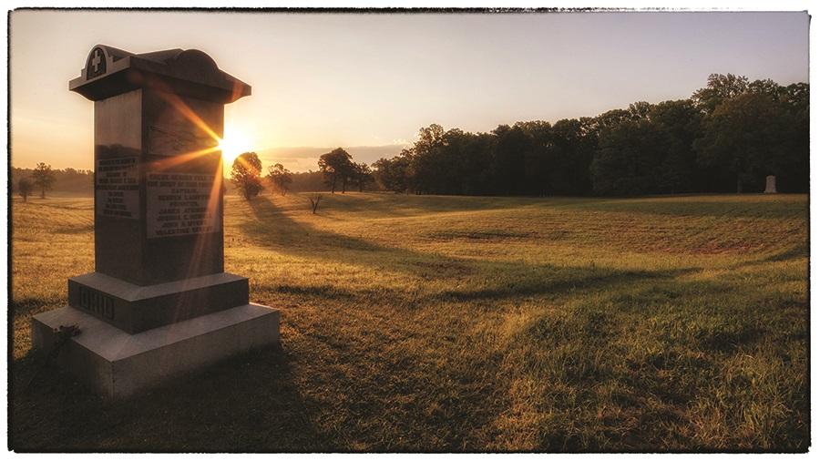 This photograph depicts a memorial at Spotsylvania during a vibrant sunset. 
