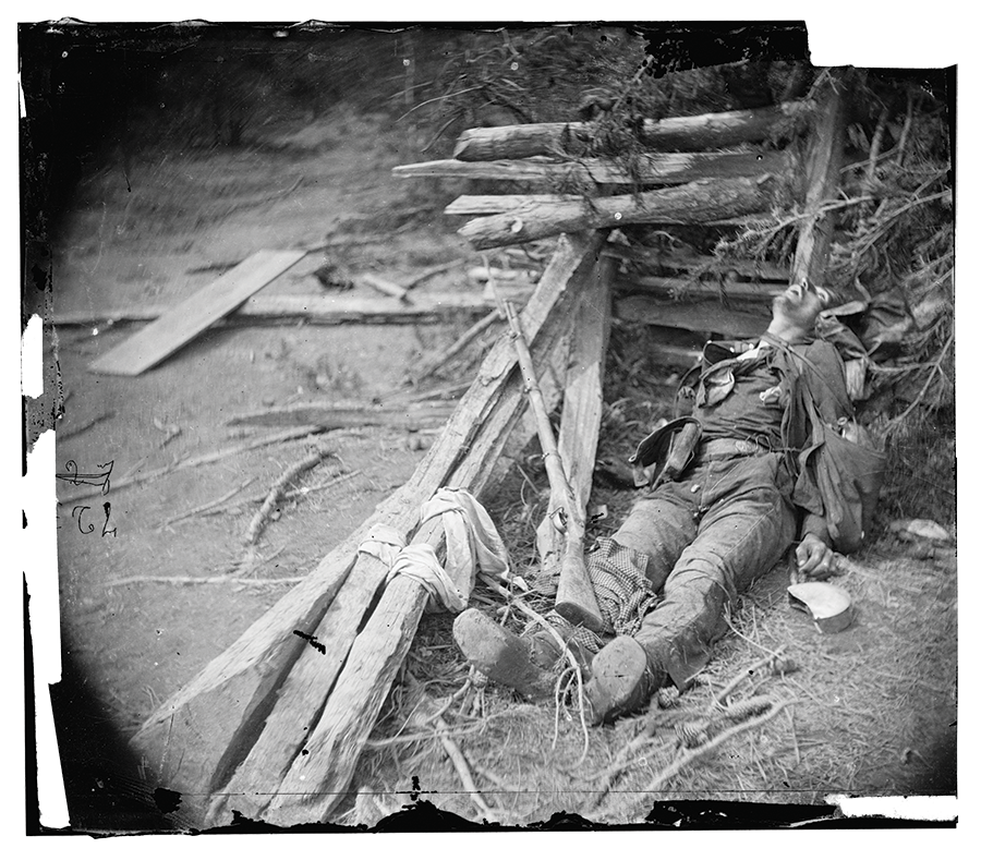 This photograph shows a soldier lying dead in the rubble of Spotsylvania. 
