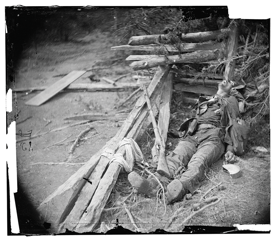 This photograph shows a soldier lying dead in the rubble of Spotsylvania.