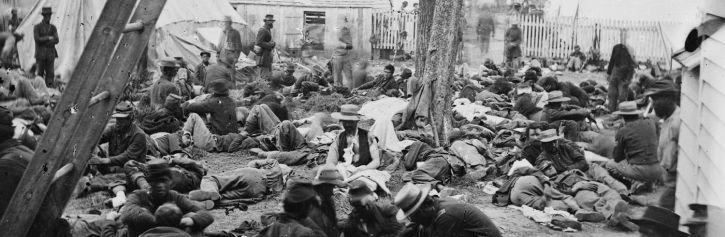 Photograph of bodies laying around at the Field Hospital at Savage Station