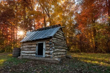 Replica civil war quarters with an Autumn backdrop at Bristoe Station Battlefield in Bristow, VA.