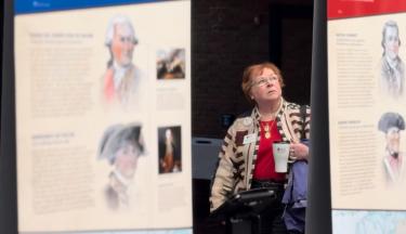 Visitor reads a American Revolution Experience panel in Lexington